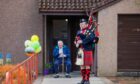 Pipe Major Alistair Duthie plays for Fred Waters in Bridge of Earn on his 100th birthday.