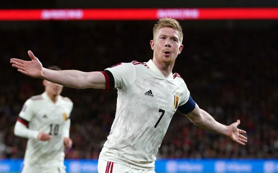 Photo shows Belgian footballer Kevin De Bruyne with arms outstretched after scoring a goal.