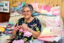 Anne Reith with the hundreds of items she has knitted for Ninewells babies. Pic: Steve Brown/DCT Media.