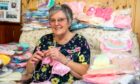 Anne Reith with the hundreds of items she has knitted for Ninewells babies. Pic: Steve Brown/DCT Media.