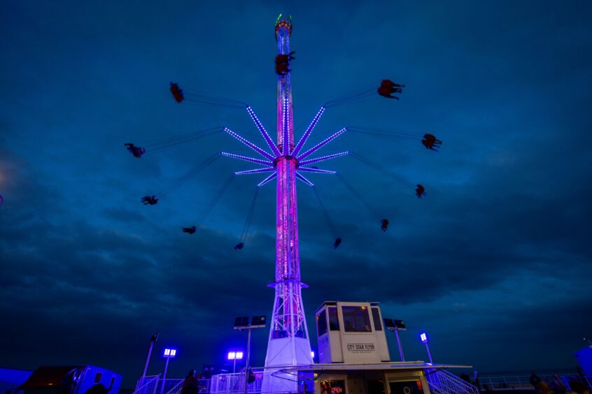 Visitors enjoy a spin on the 180ft Skyflyer ride. 