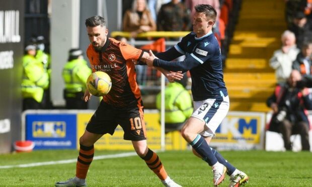 Nicky Clark and Jordan Marshall battle in a 2022 Dundee derby at Tannadice. Image: SNS