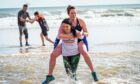 Gayle joins a military fitness bootcamp at Balmedie beach and gets stuck in giving Pamela Dawson a piggyback. Picture: Wullie Marr.
