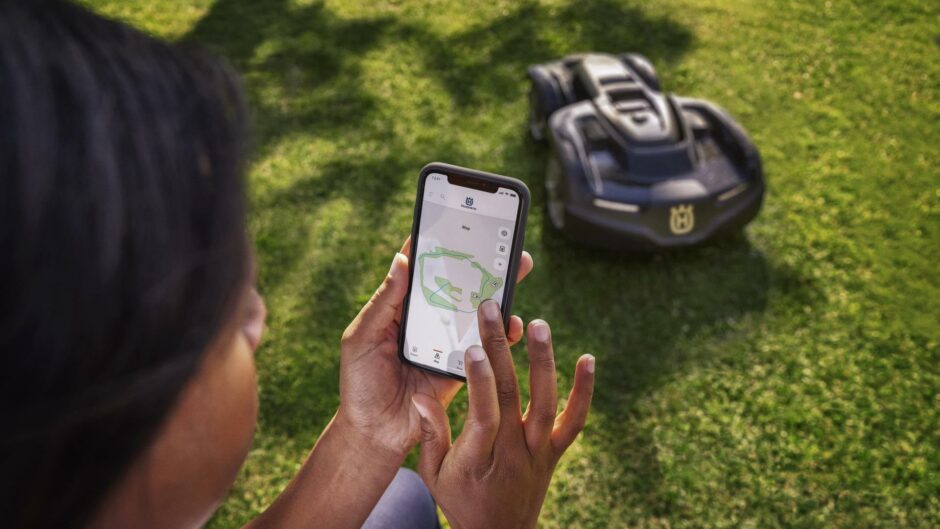 ©Husqvarna person using app to control automated lawn mower