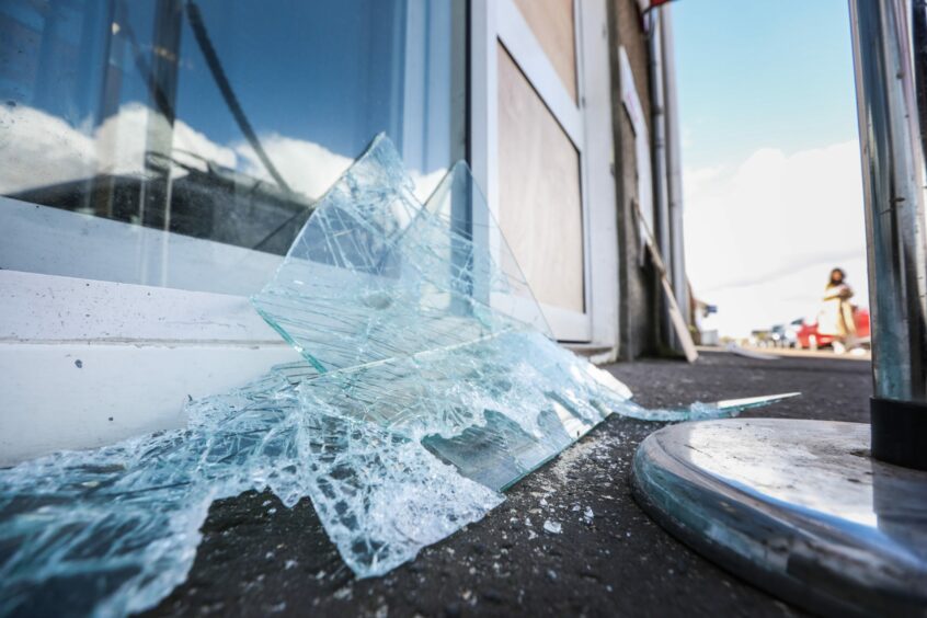 Broken glass at the entrance to the Carnoustie shop