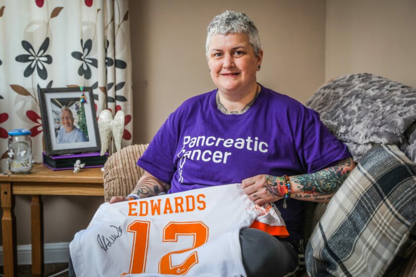 Karen at home in Forfar, holding the Dundee United top signed by Ryan Edwards.