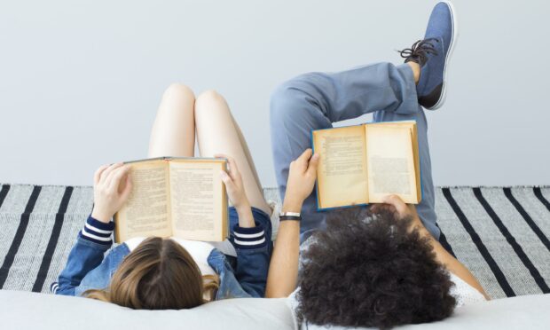Young people reading book; Shutterstock ID 698403418; purchase_order: ; job: