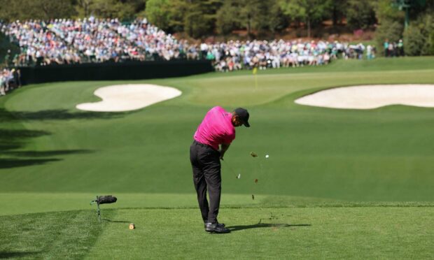 Tiger Woods hits his tee shot on the fourth hole during the first round of the Masters.