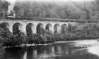 Train passengers stand on the Killiecrankie Viaduct in the early 1900s.