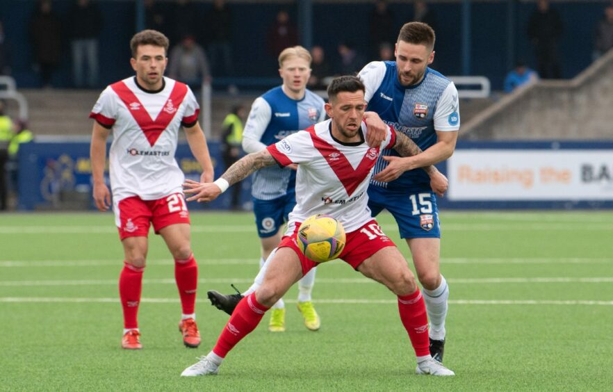 Montrose midfielder Mark Whatley hounds Dylan Easton of Airdrie.