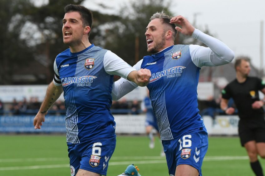 Terry Masson (left) and Craig Johnston celebrate the early goal.
