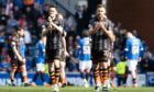 Smith, left, and Ryan Edwards salute the travelling fans on Sunday