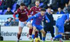 Michael McKenna of Arbroath tussles with Logan Chalmers