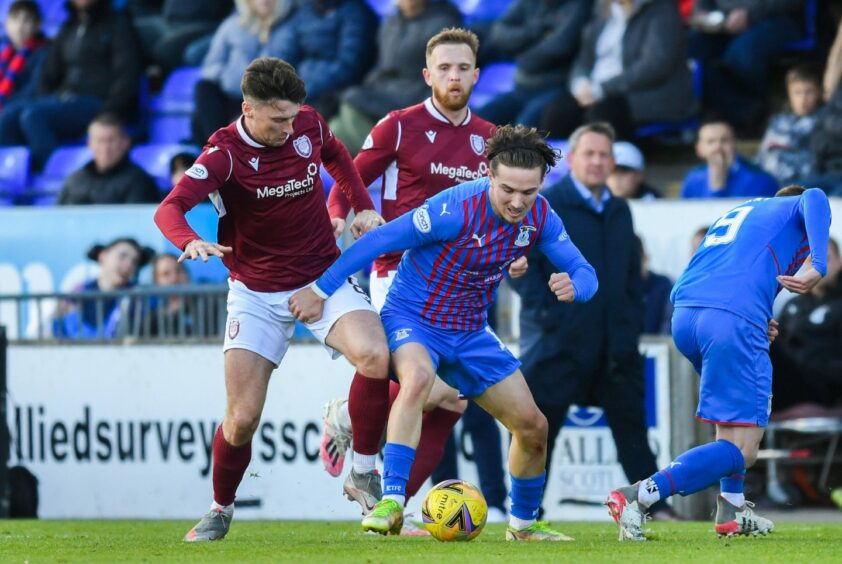 Michael McKenna of Arbroath tussles with Logan Chalmers