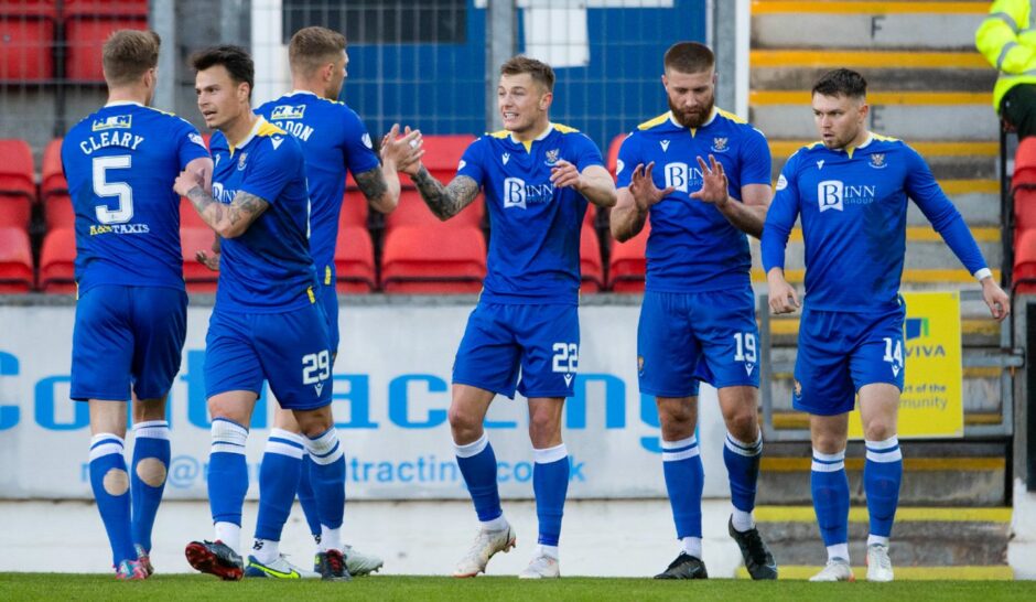 The Saints players celebrate the winning goal.