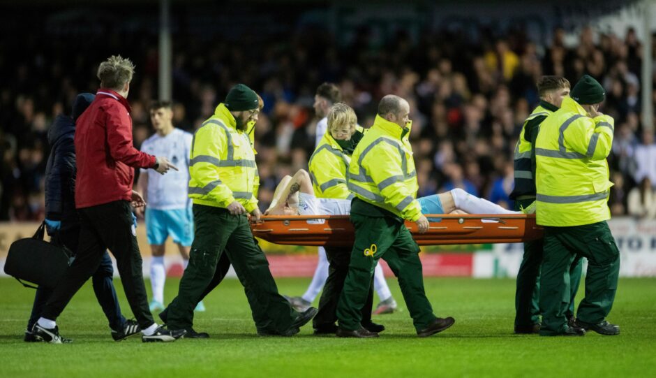 Shane Sutherland is stretchered from the field.