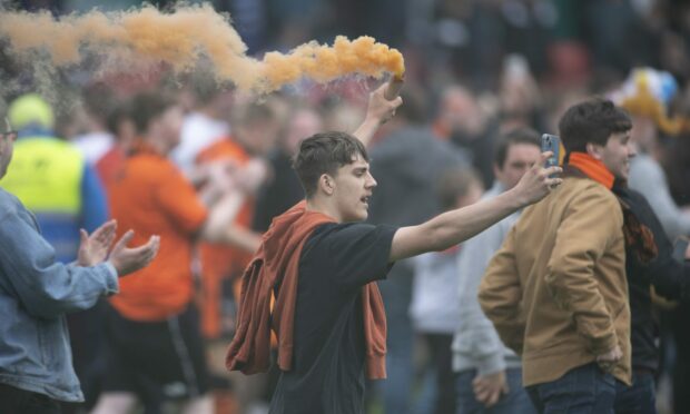 The United fans enter the pitch