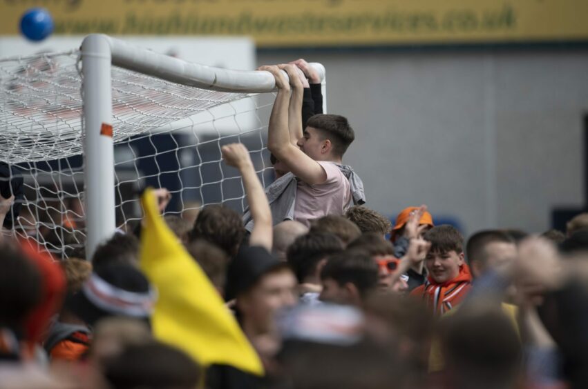 United fans on the pitch in Dingwall