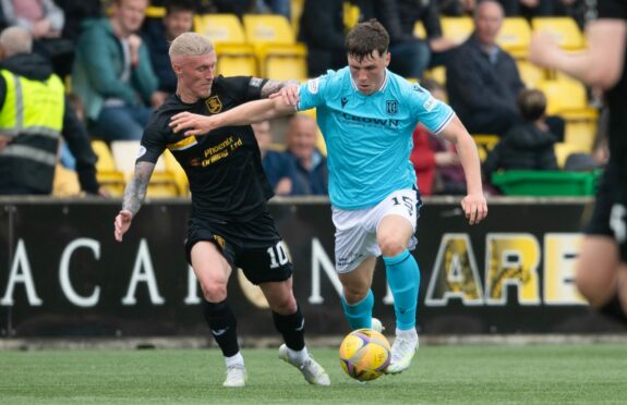 Dundee's Josh Mulligan holds off Craig Sibbald of Livingston.