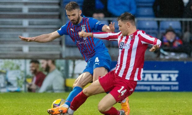 Sean Welsh is tackled by Glenn Middleton.