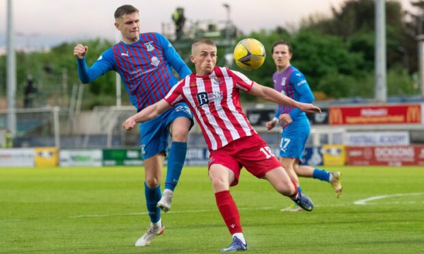 Cammy MacPherson beats Reece MacAlear to the ball during the Premiership Play-Off final first leg.