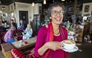 Rachel Weiss smiling as she holds a cup of coffee at Blend coffee lounge in Perth