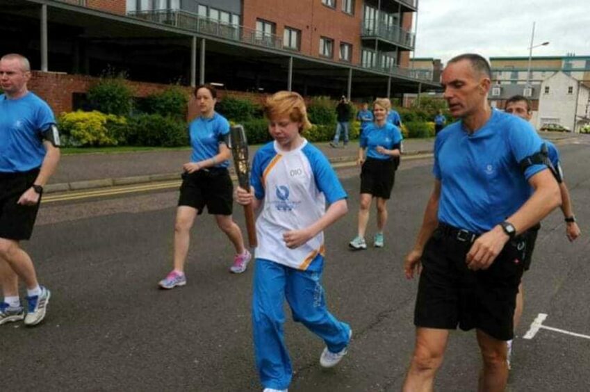 Andrew was the youngest person in Dundee to hold the Queen's Baton ahead of the 2014 Commonwealth Games.