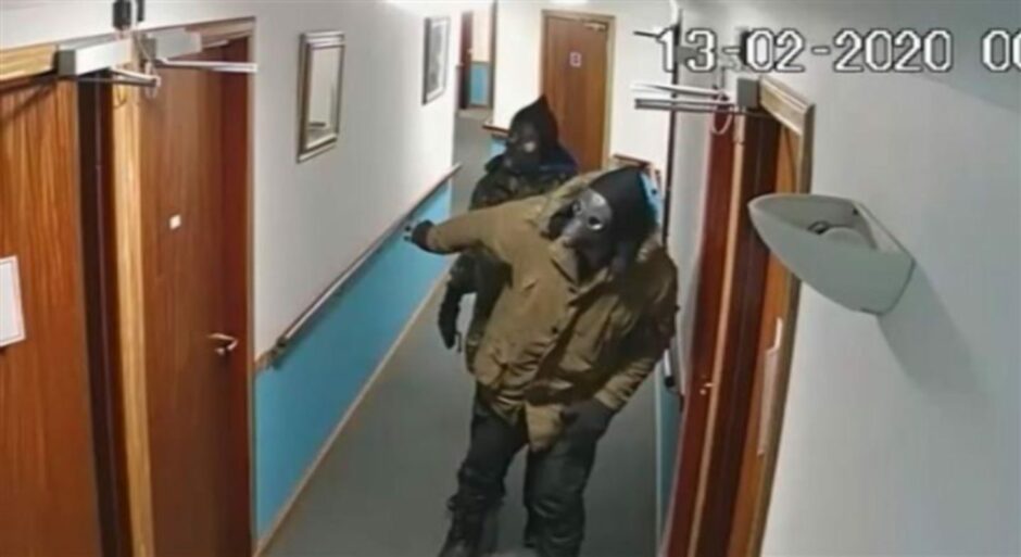 The thieves creep to their target's care home room in their masks.