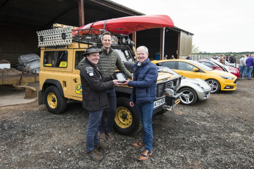 Paul Bracey receives the award from Graham Brown and Ed Foster of The Rhynd.