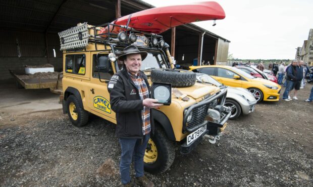 Paul Bracey with the inaugural Bacon and Brakes trophy and his 1986 Land Rover.