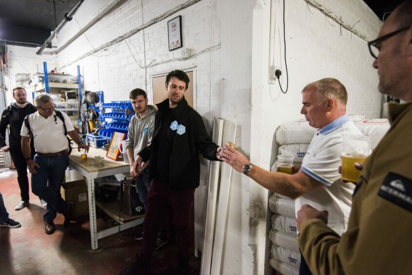 Brewer Gareth Cooper shows some of the malted barley used in the process.