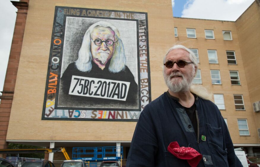 Kohli's hero Billy Connolly in front of John Byrne's portrait in mural form in Glasgow's Osborne Street. 