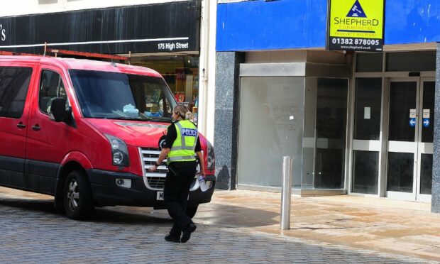 Police on High Street in Kirkcaldy, near the scene of the raid.