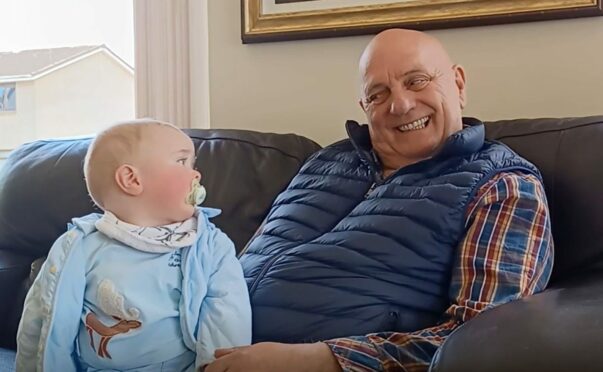 Dick Campbell sits proudly with grandson Rian on his lap.