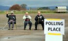 Independent candidate Colin Brown (right) having a seat in the sun with two other gentlemen after voting at Strathmore Hall in Forfar.