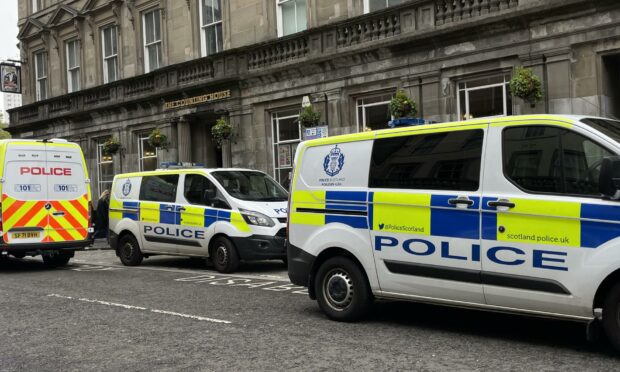 Police on Reform Street in Dundee, outside The Counting House pub.