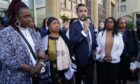 Sheku's mother Aminata Bayoh (2nd left) with Sheku's sisters and Lawyer Aamer Anwar (centre) speaks to supporters outside Capital House before the start of a public inquiry.