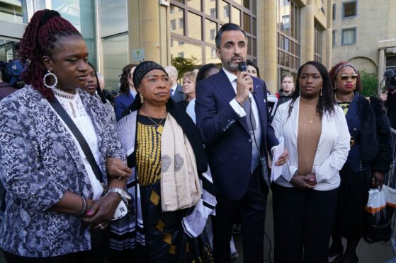 Sheku's mother Aminata Bayoh (2nd left) with Sheku's sisters and Lawyer Aamer Anwar (centre) speaks to supporters outside Capital House before the start of a public inquiry.