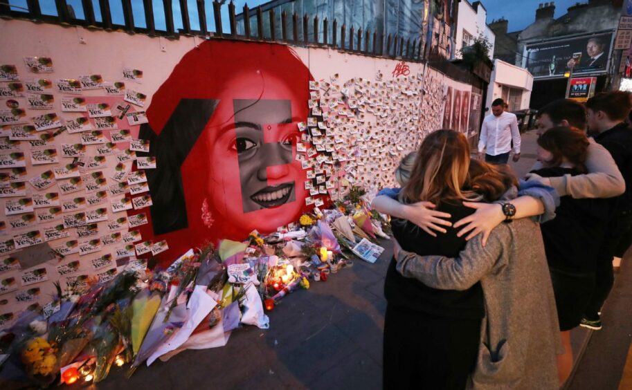 Candles and flowers in front of a mural of Savita Halappanavar in Dublin.