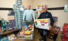 Jim Sorrie and Colin Lamb load up donations at the food larder.