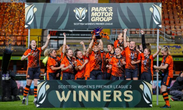 United skipper and lifelong Dundee United fan Megan Burns lifts the trophy