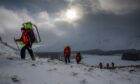 Tayside police mountain rescue team members training in snow-covered Glen Clova.