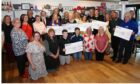 The charity cheques handover marking the end of an era for Angus Minstrels