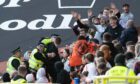 Noon is led away from Tannadice after his arrest.