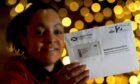 Postal worker Patrona Tunilla holds a sample Scotland's Census letter during the launch of Scotland's Census 2022