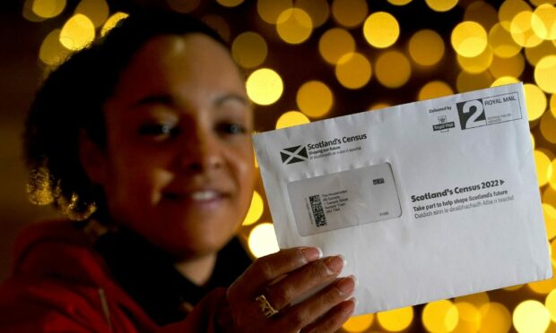Postal worker Patrona Tunilla holds a sample Scotland's Census letter during the launch of Scotland's Census 2022
