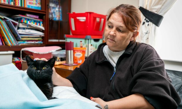 Stephanie Clark with family cat Buttons.