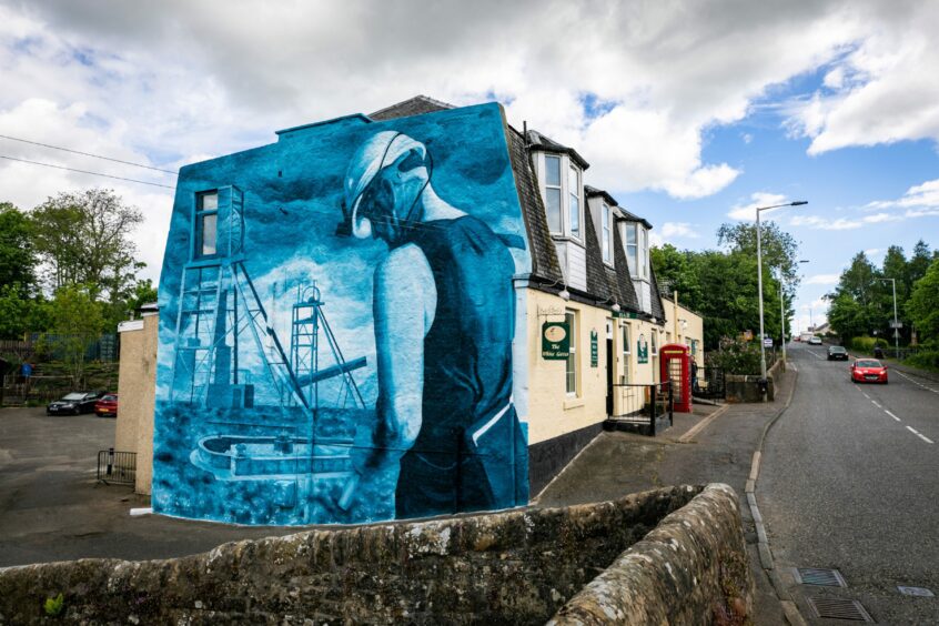 The mural on the side of the pub in the Fife town of Comrie. 