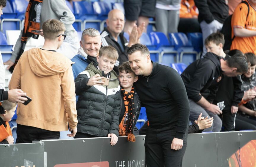 Tam Courts poses for pictures with young Dundee United fans