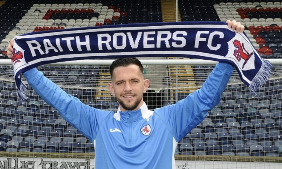Dylan Easton holds up a Raith Rovers scarf on the day he signed from Airdrie in summer 2022.